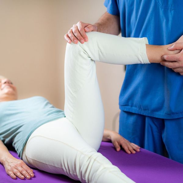 chiropractor working on patient's leg