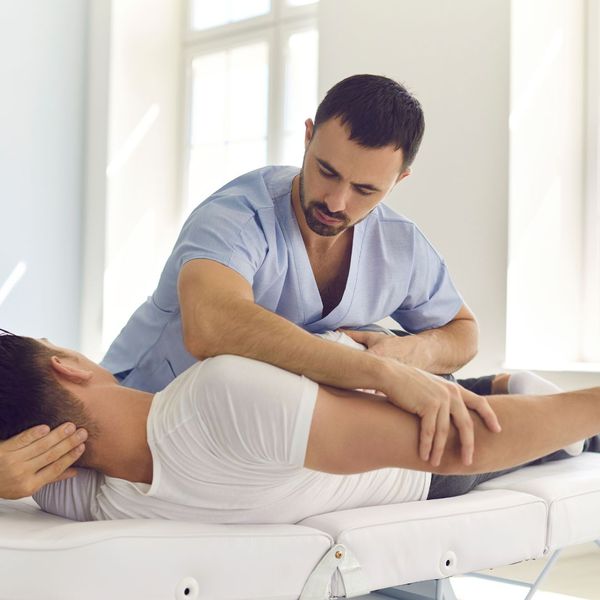 chiropractor working on patients arm