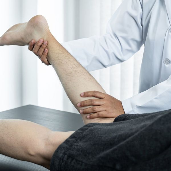 chiropractor working on patient's leg